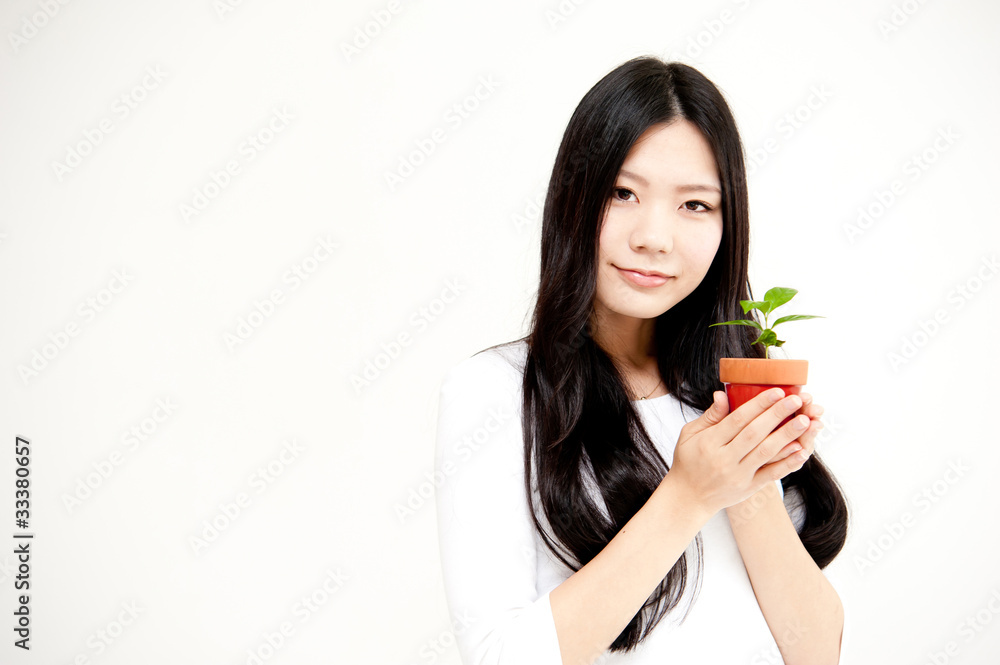 beautiful asian woman with small plant