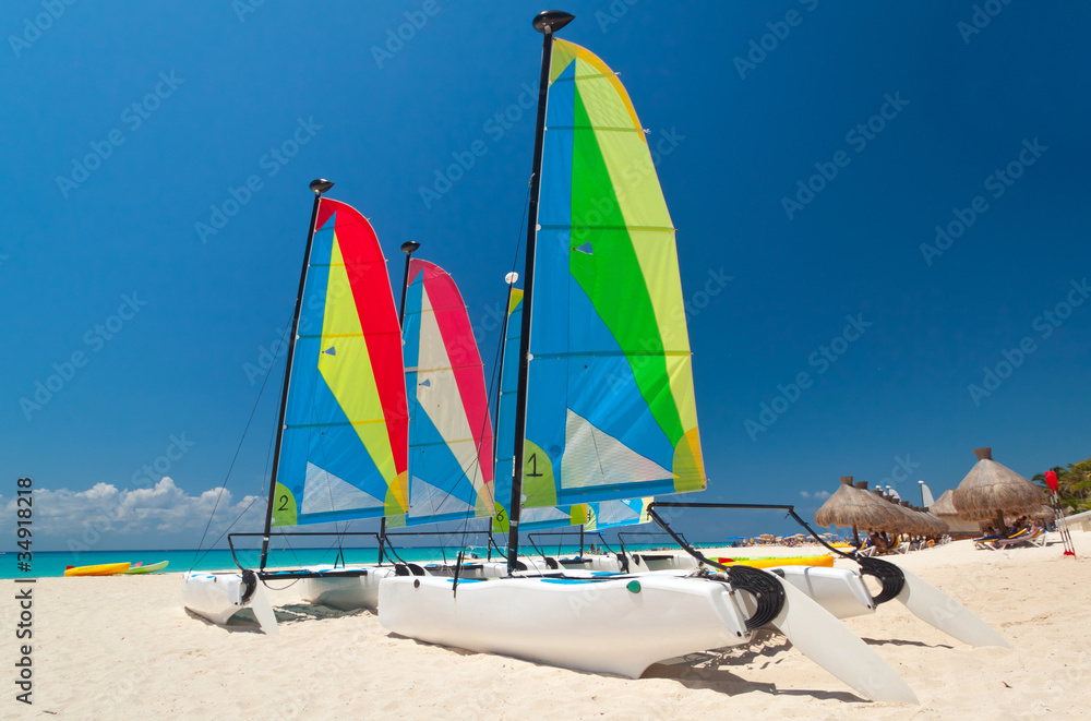 Colorful sail catamarans on the Caribbean beach