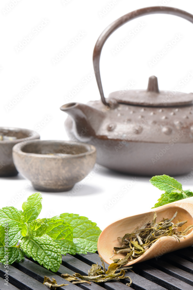 Asian tea set with dried green tea and fresh mint