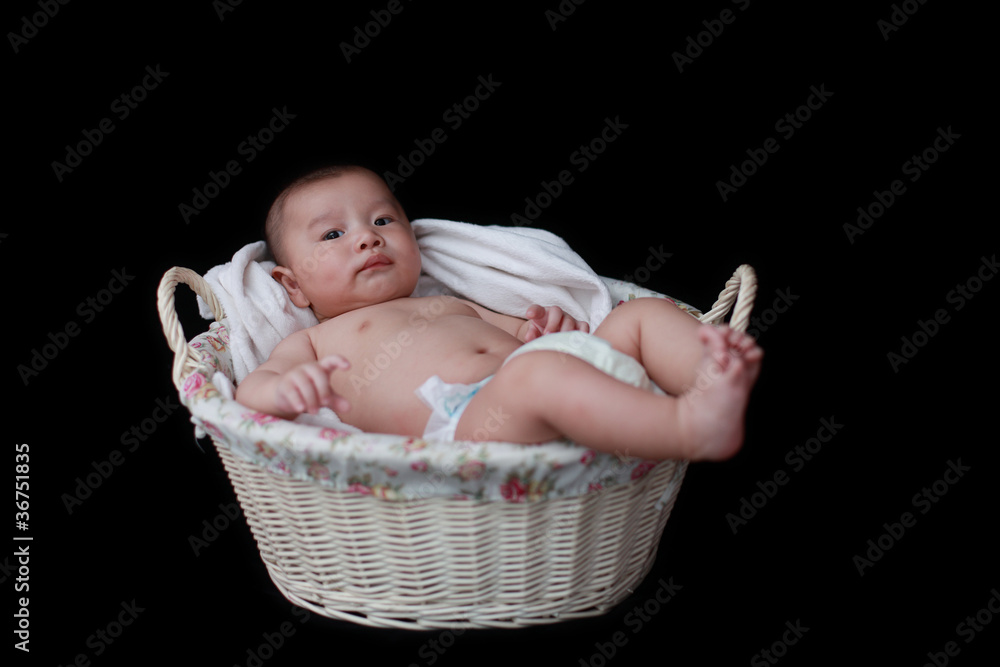 cute baby in  basket with black background