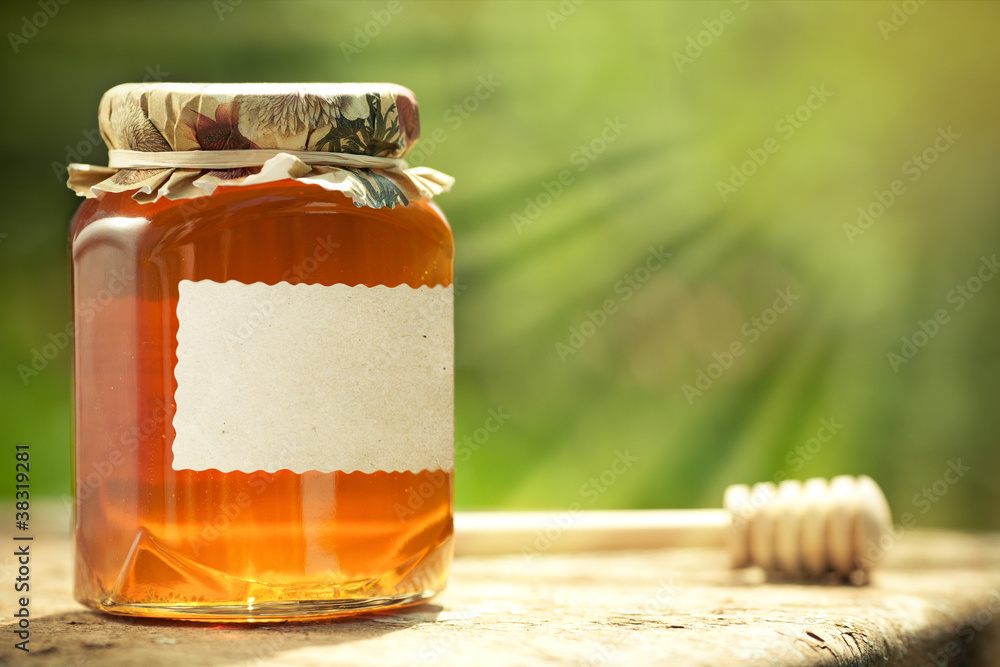 Flowery honey in glass jar