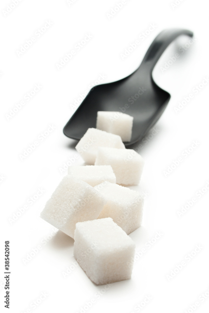 Cubes of sugar with plastic spoon