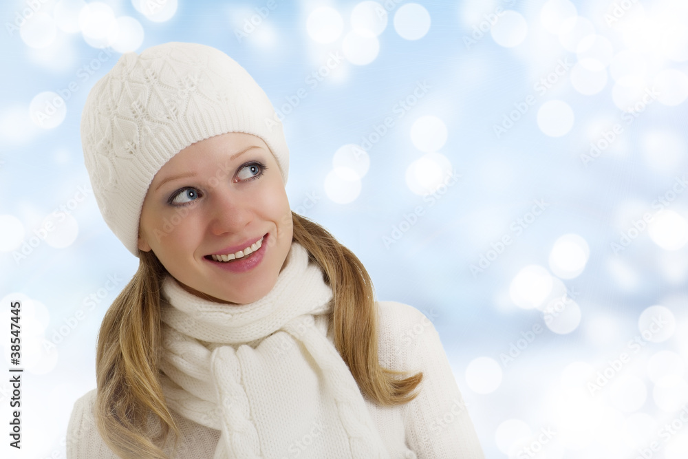 beautiful happy young woman in a winter hat and scarf