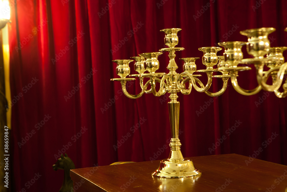 Antique candelabra with red background