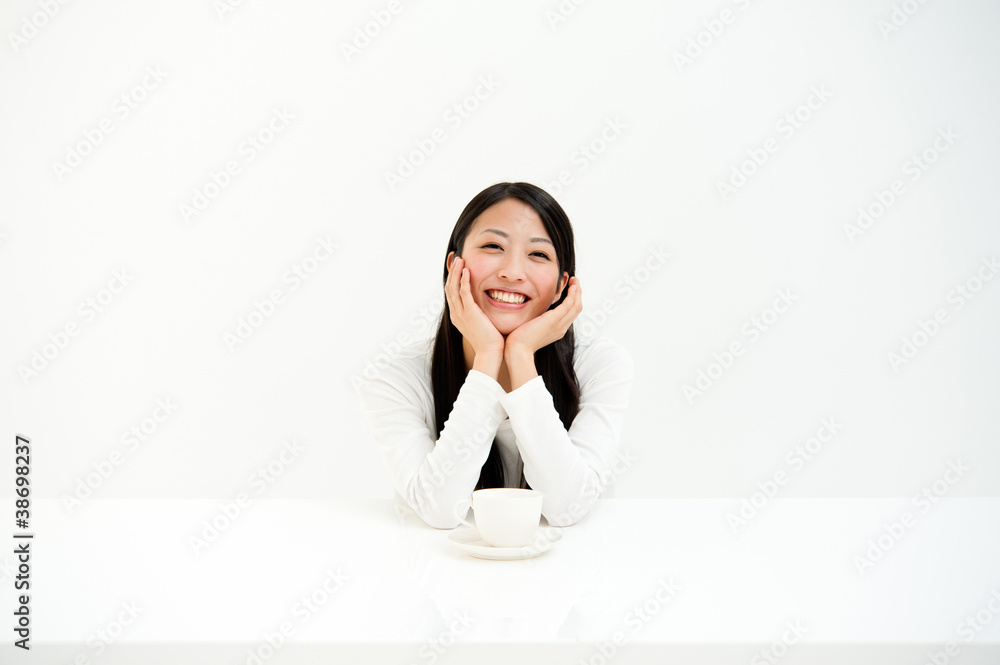 attractive asian woman drinking in the white room