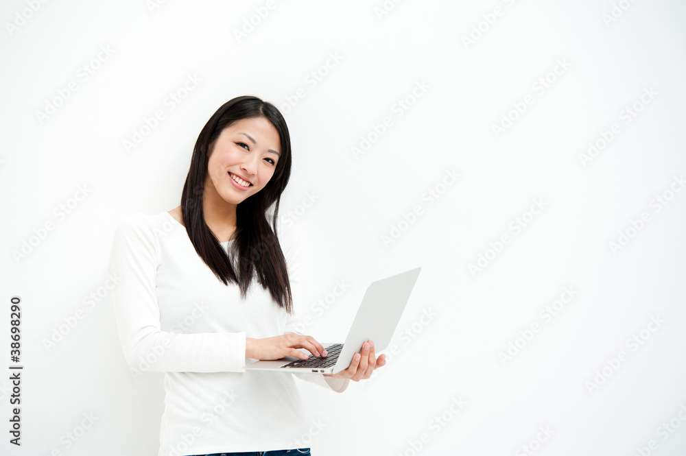 attractive asian woman using laptop in the white room