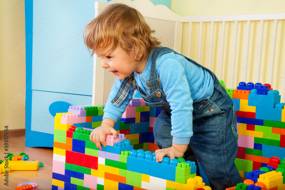 Happy kid claiming out of toy block