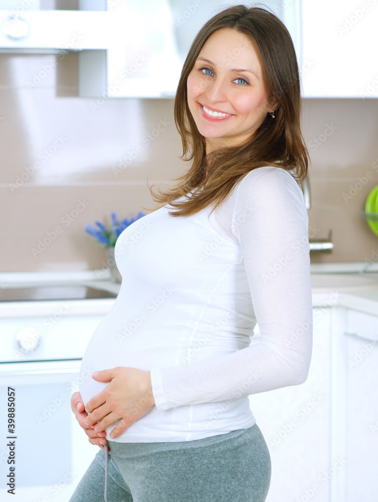 Pregnant Young Woman at home. Happy Pregnancy