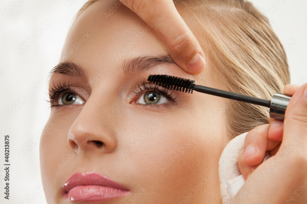 separating and curling lashes with mascara brush