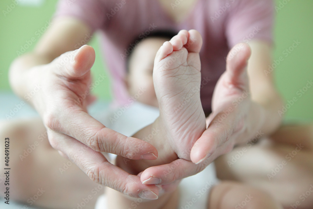 Tiny baby feet in his father hands