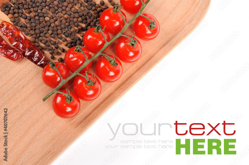 Tomatoes and peppers on wooden board