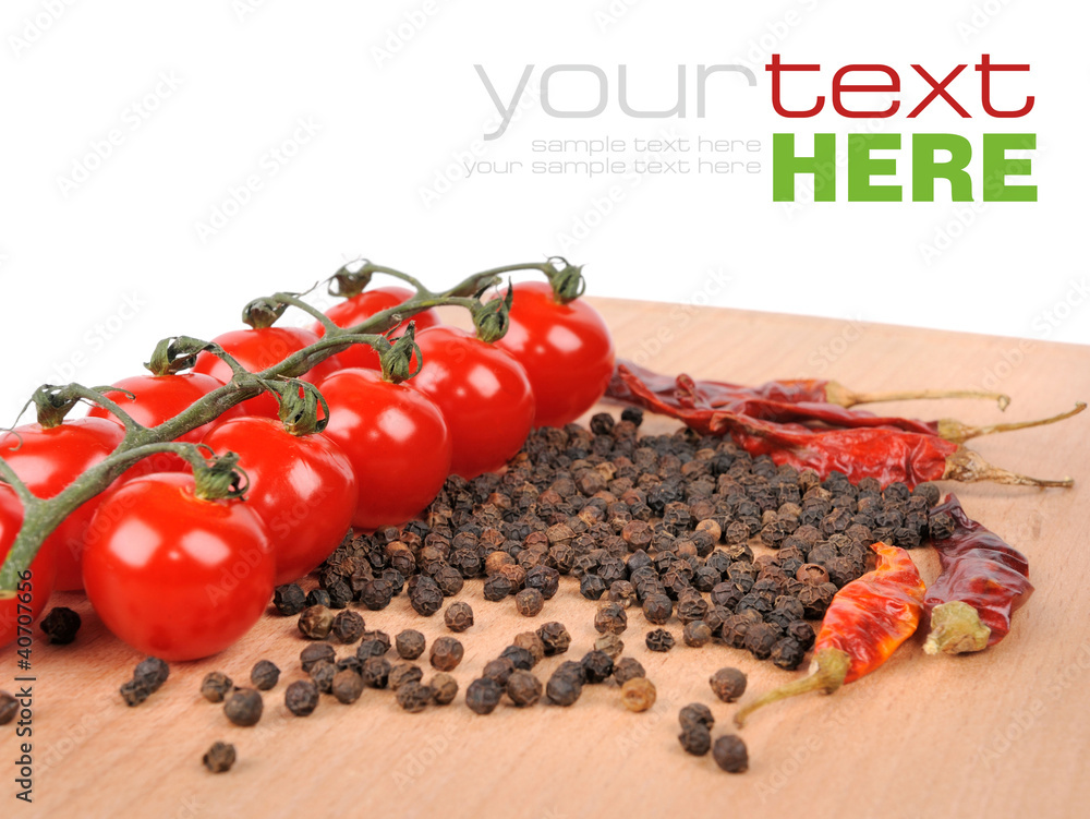 Tomatoes and peppers on wooden board