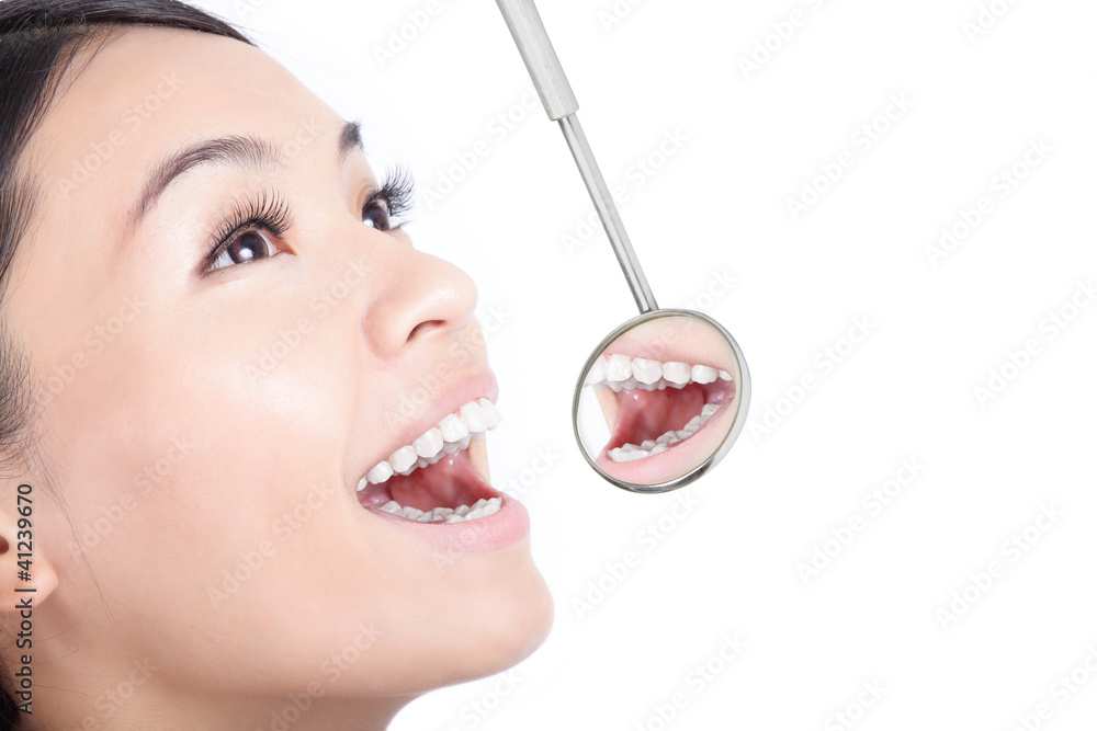 Healthy woman teeth with a dentist mouth mirror