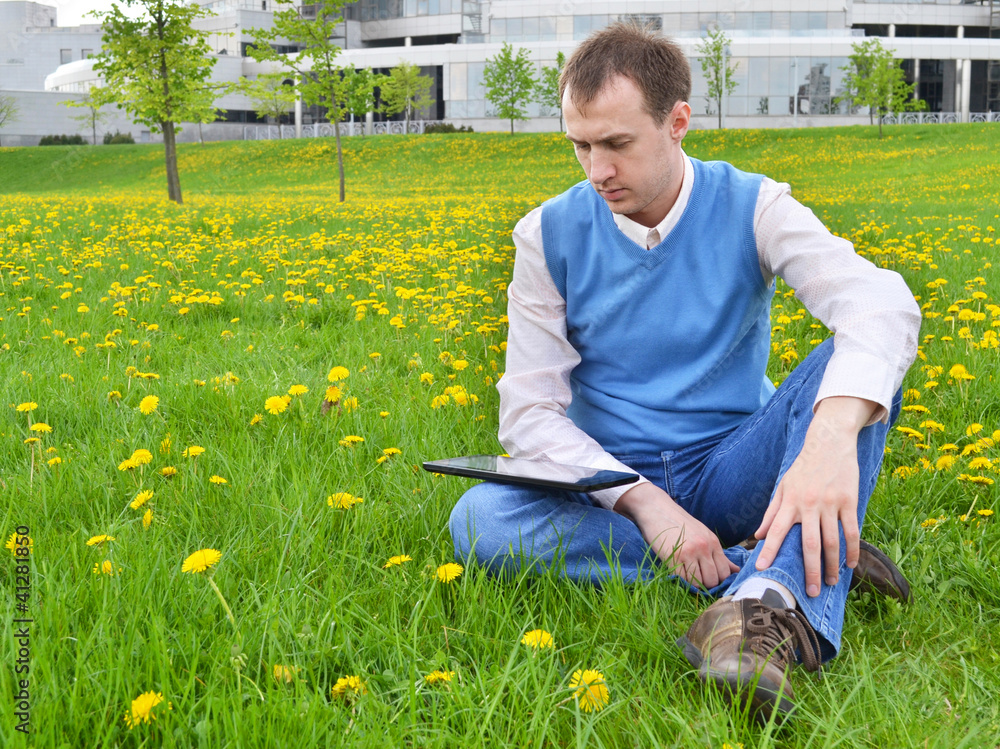 Businessman at the park with tablet.