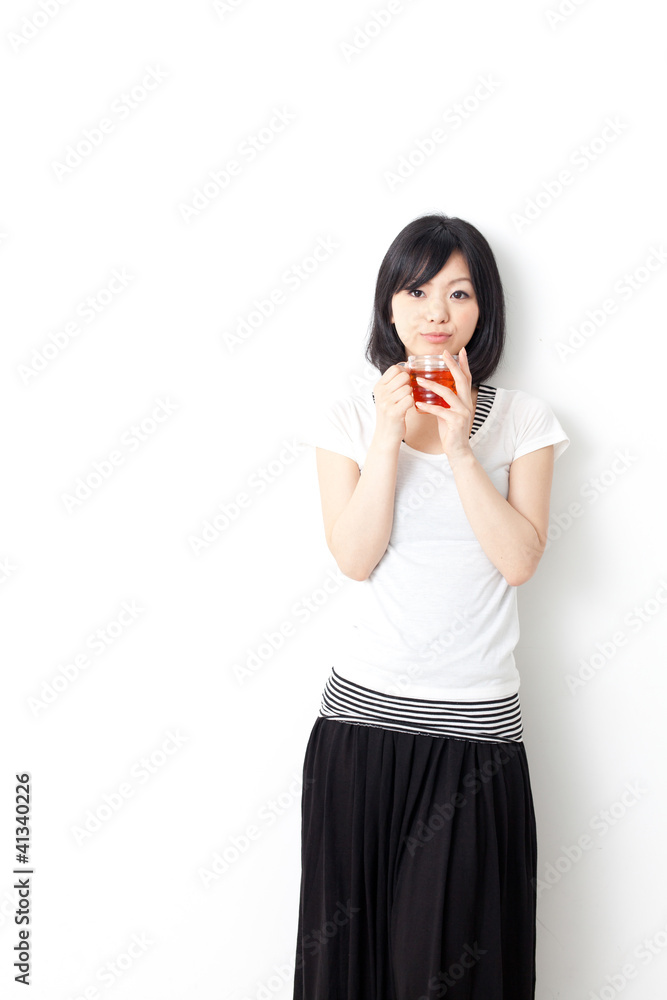 attractive asian woman drinking a cup of tea