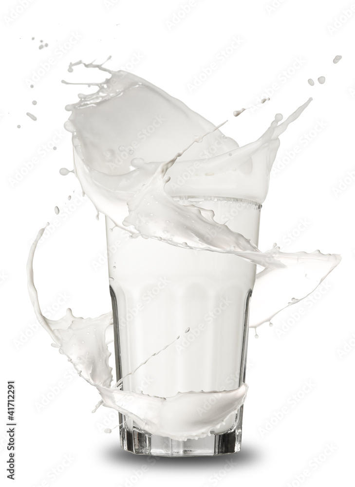 Milk splashing out of glass, isolated on white background