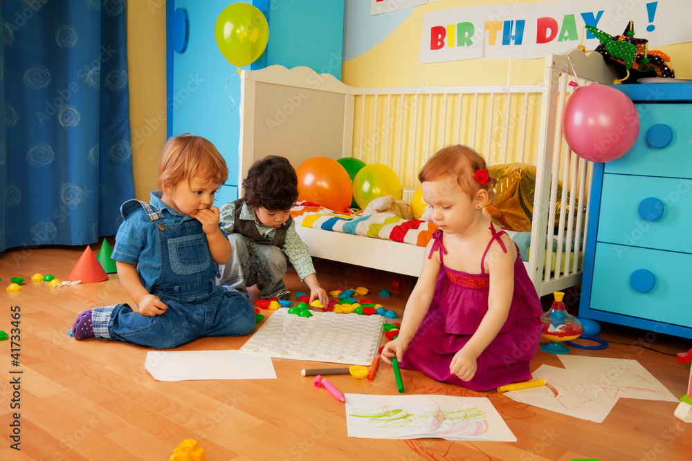 Tree kids drawing together