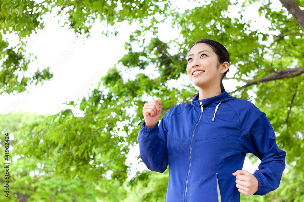 young asian woman running in the park