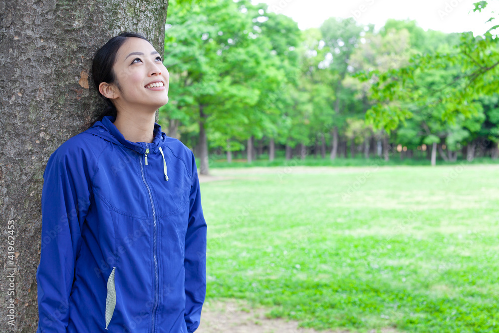 young asian woman relaxing in the park