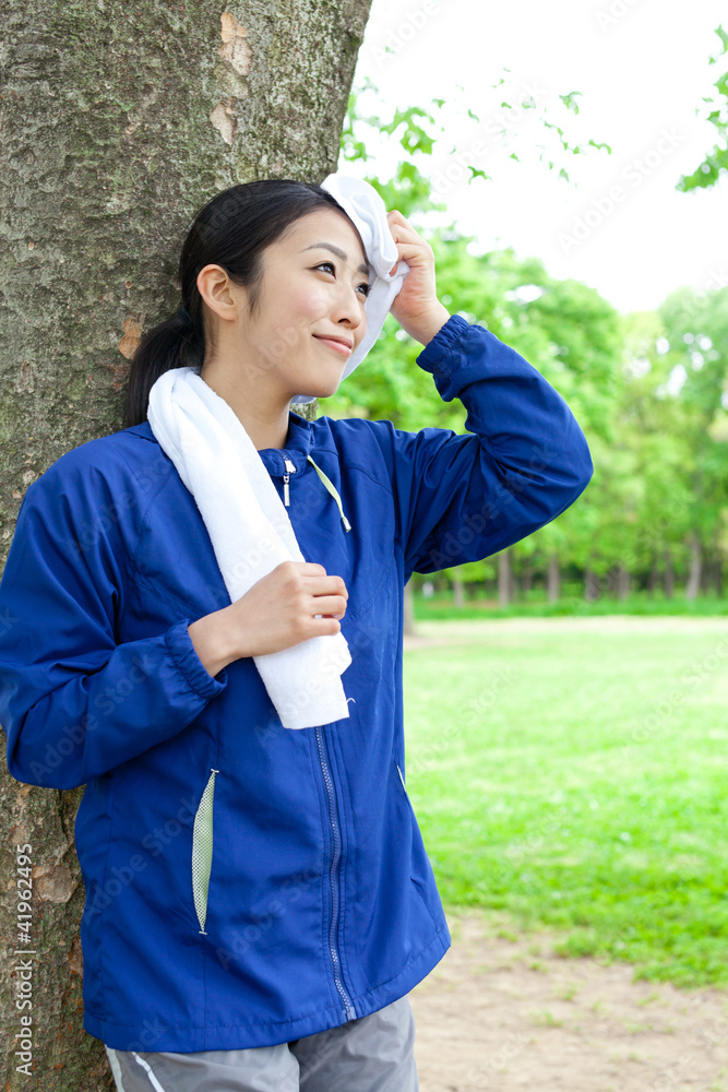 年轻的亚洲女人在公园里放松