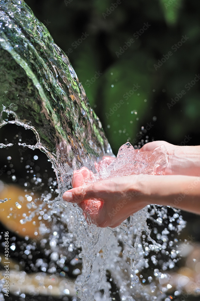 Womans hands with water splash