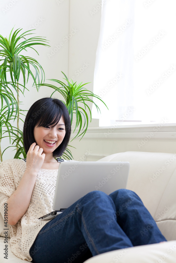 a young asian woman using laptop computer