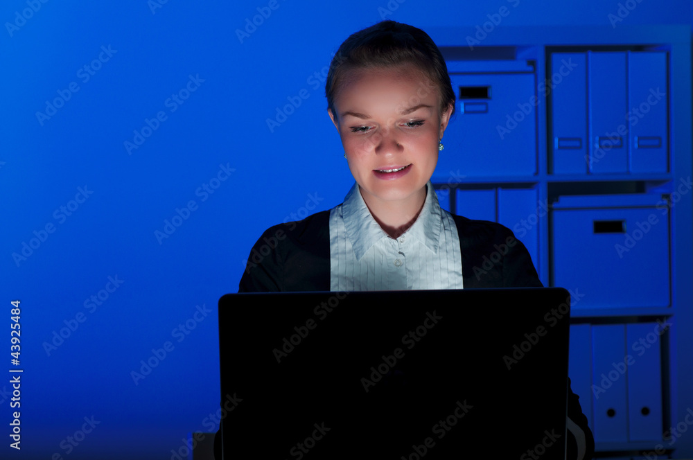 portrait of a woman in a night office, working all night