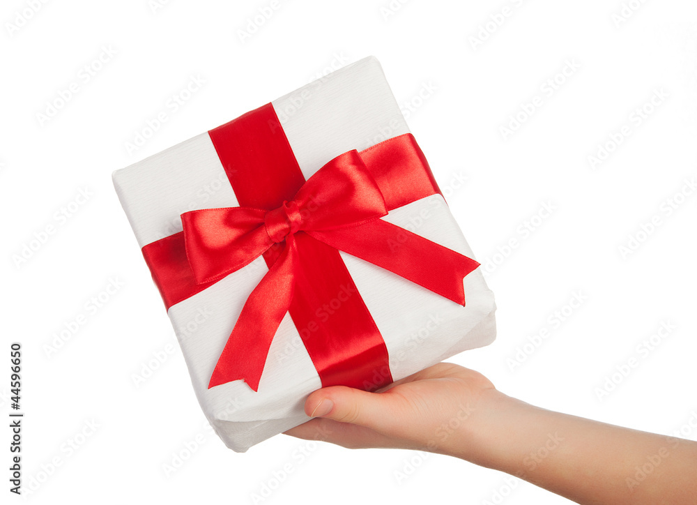 hand with a gift with a red ribbon isolated over white