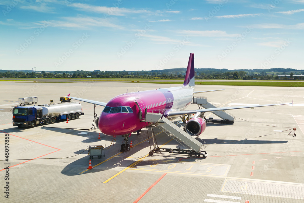 Large tourist airplane waiting on airport