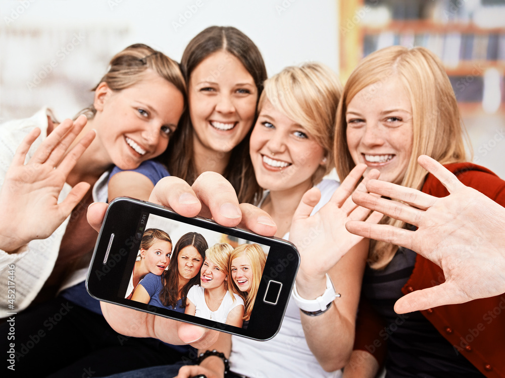 4 girls with self-portait on the smartphone