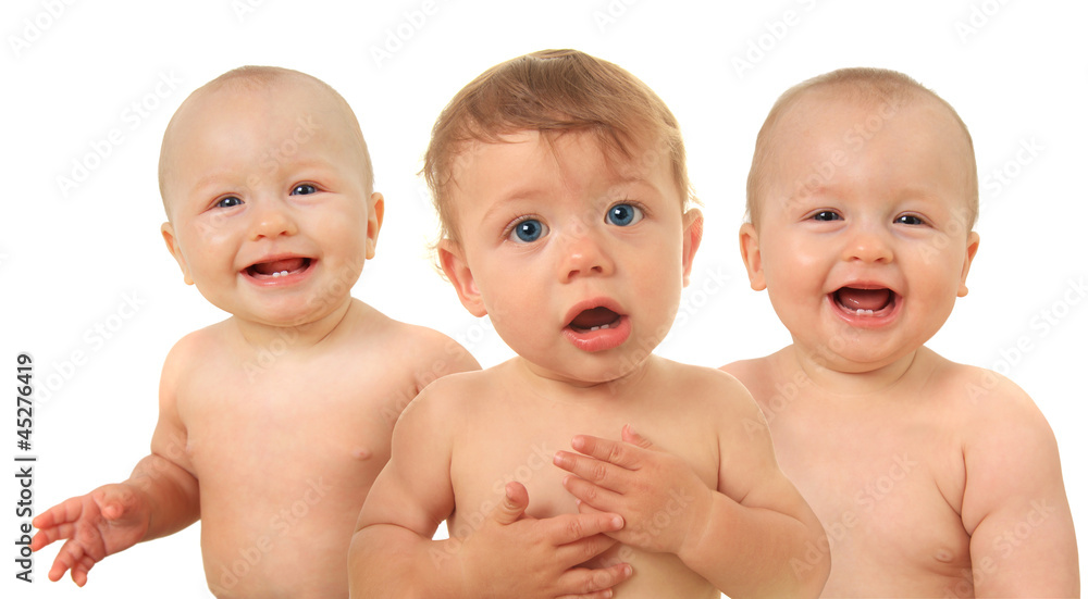 Three babies, boy in front, two girls behind him.