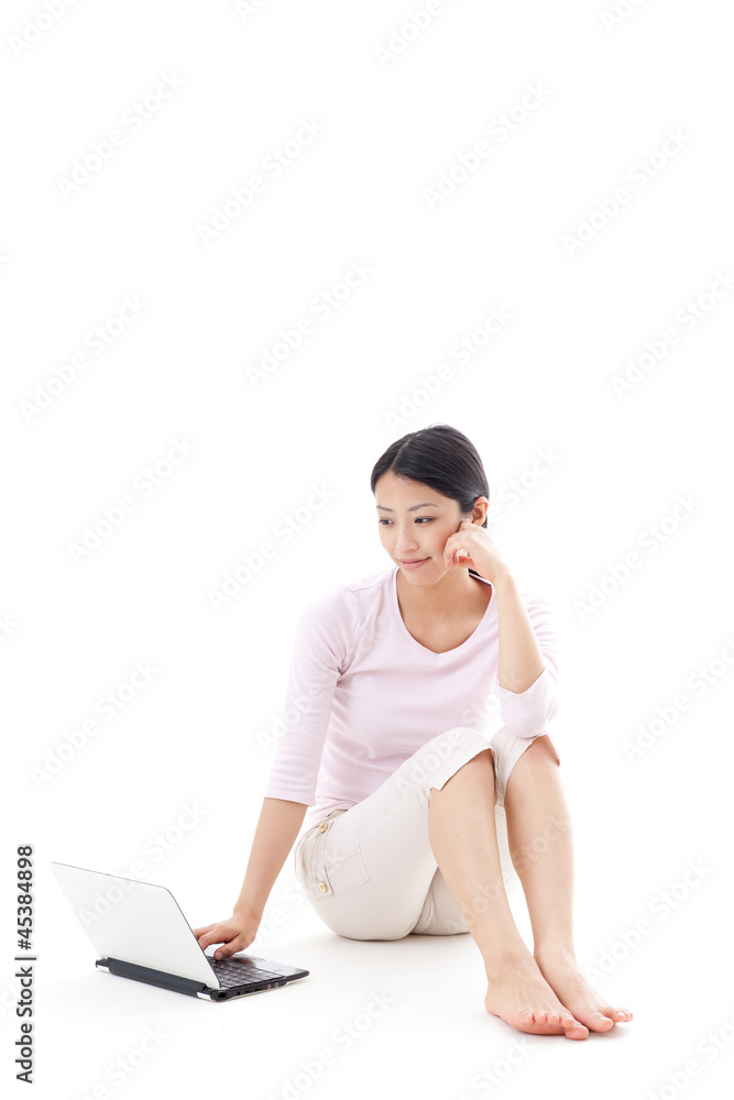 a young asian woman using laptop on white background