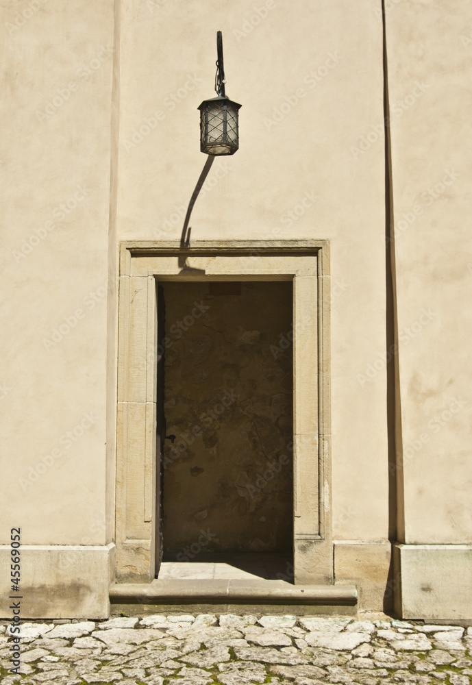 Old entrance with lamp in castle