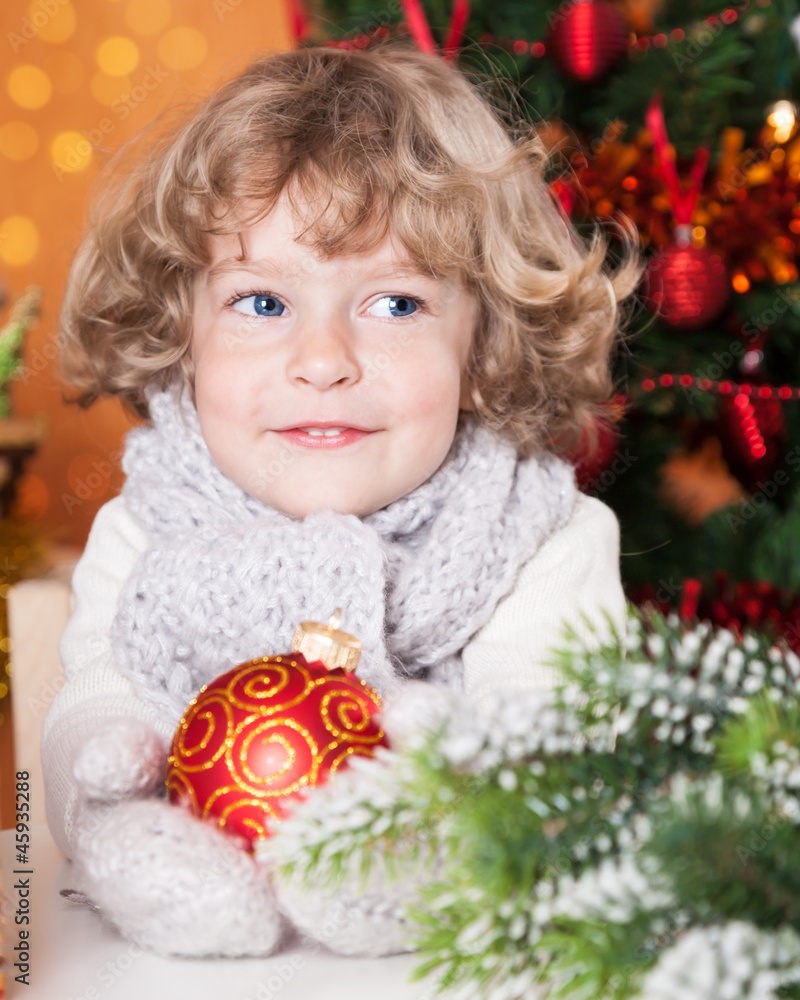 Happy child holding red ball