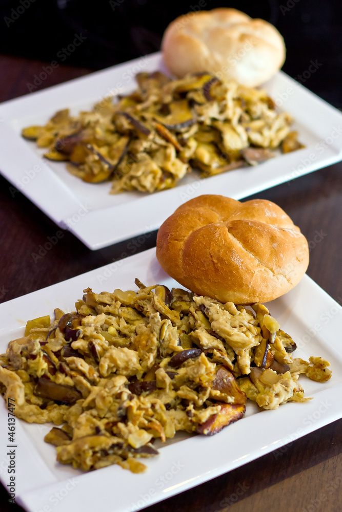 Breakfast from scrambled eggs with forest mushrooms