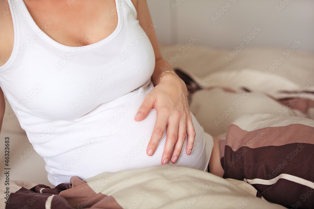 Pregnant woman caressing her belly