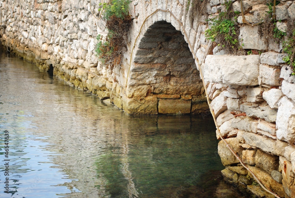 Old stone bridge over the river in Croatia