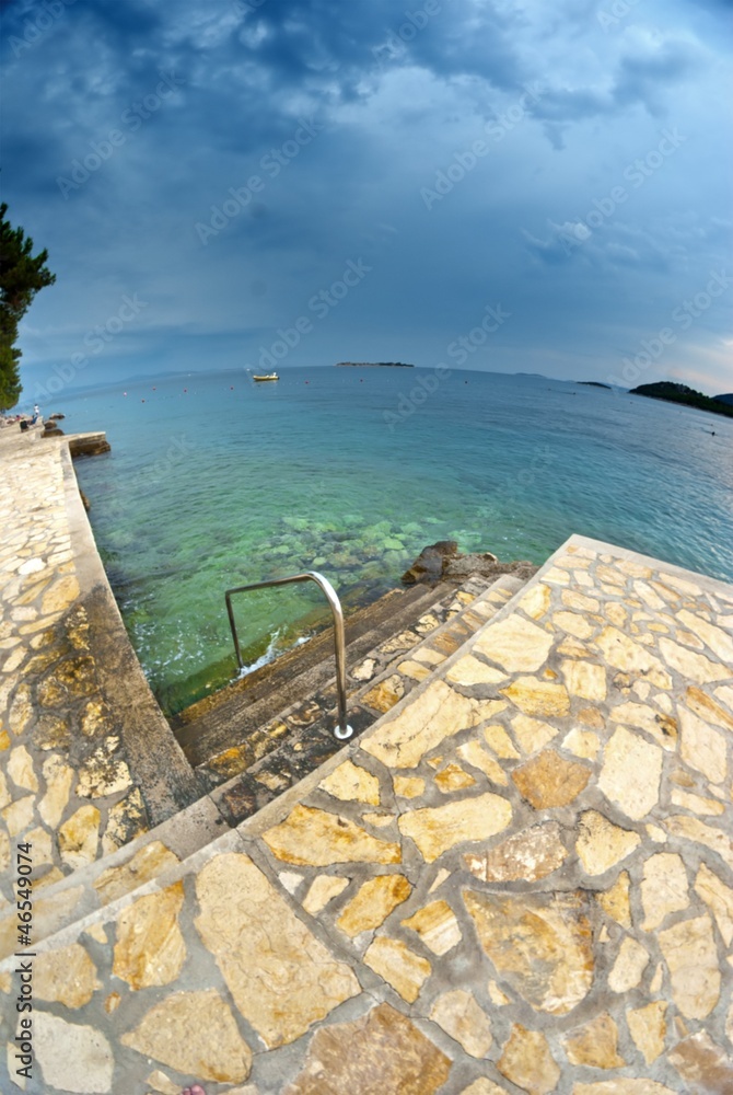 Beach and clear sea with clouds, Croatia Dalmatia