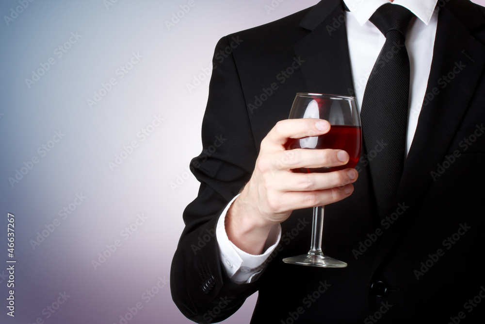 Young man holding a glass of red wine