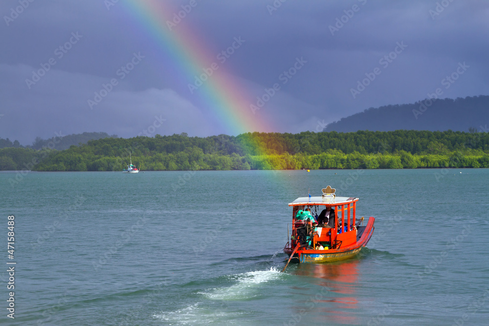 Rainbow and boat on the river at Koh Kho Khao in Thailand