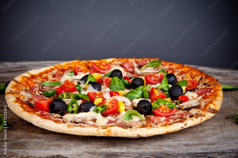 Delicious italian pizza served on wooden table