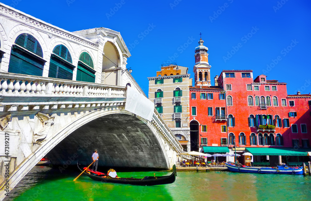 Famous Rialto bridge with Gondola in Venice, Italy