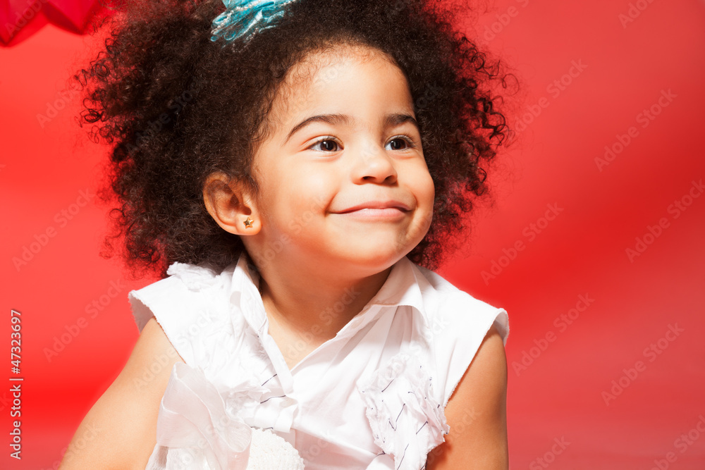 Portrait of little black curly haired girl