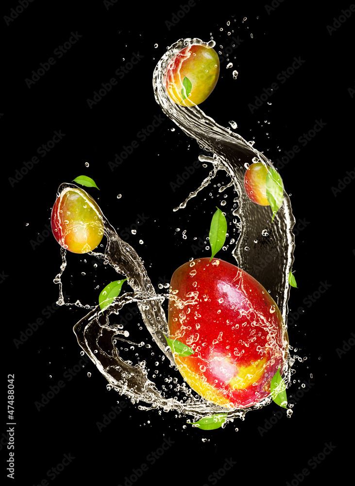 Mangos in water splash, isolated on black background