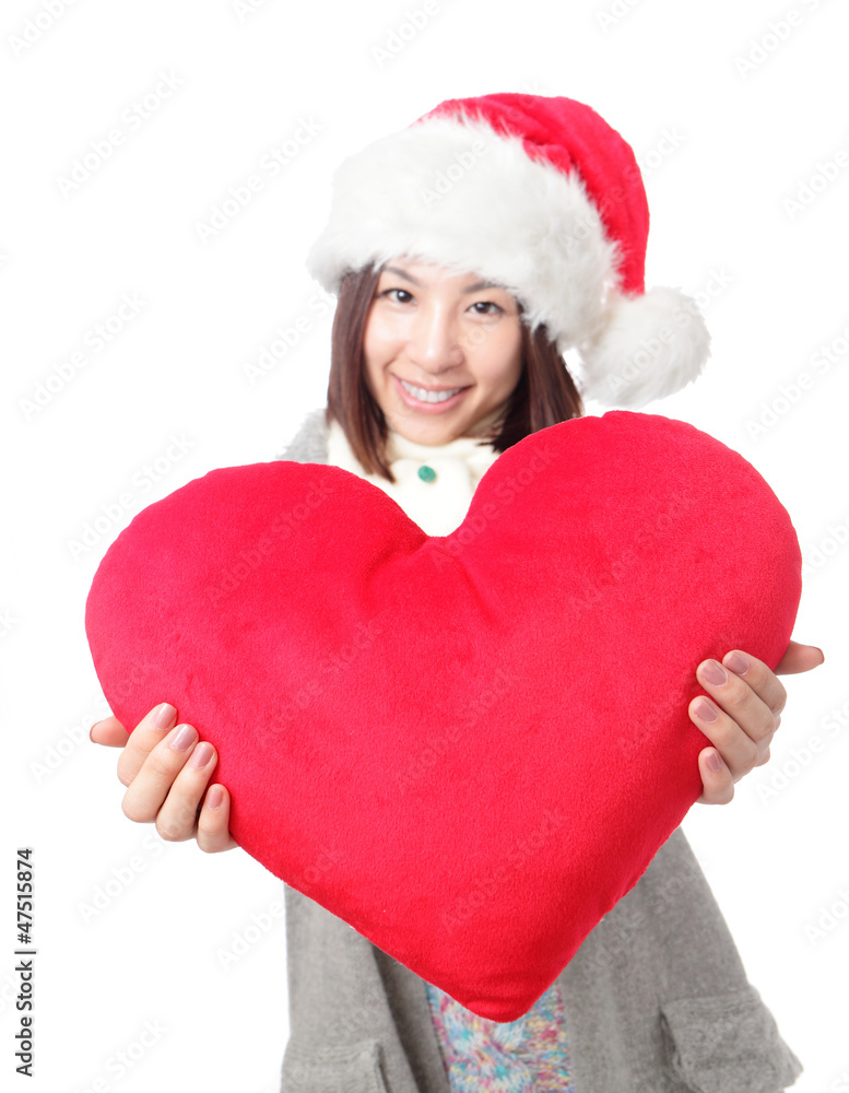 Beautiful girl in Santa hat holding love pillow