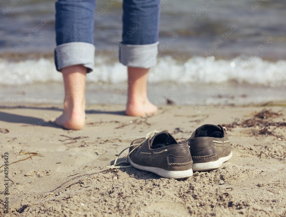 Man Leaving His Shoes Behind on the Sand