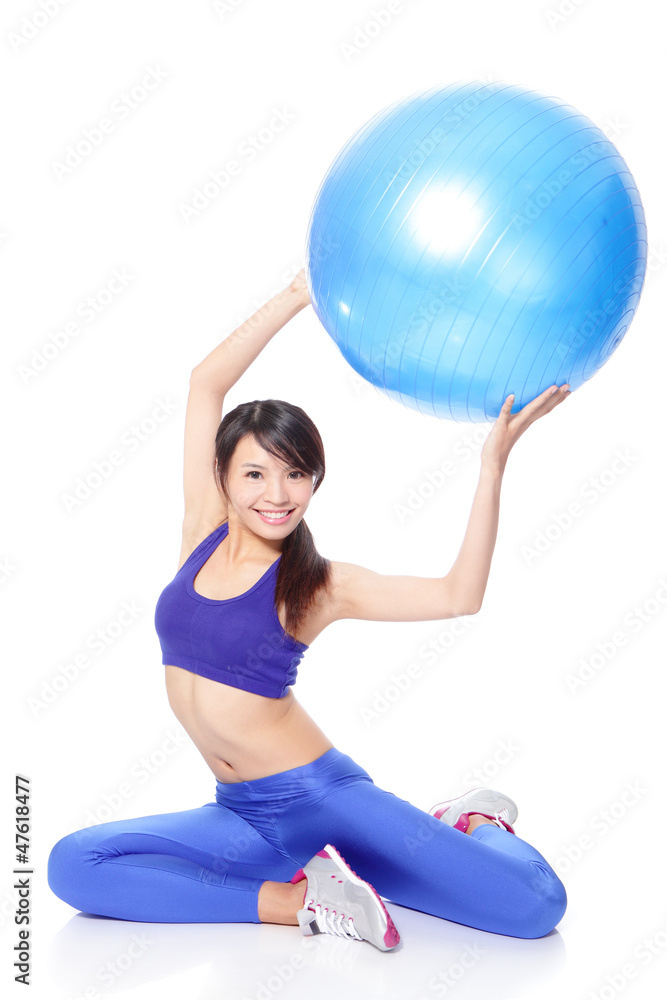 Woman holding fitness ball up