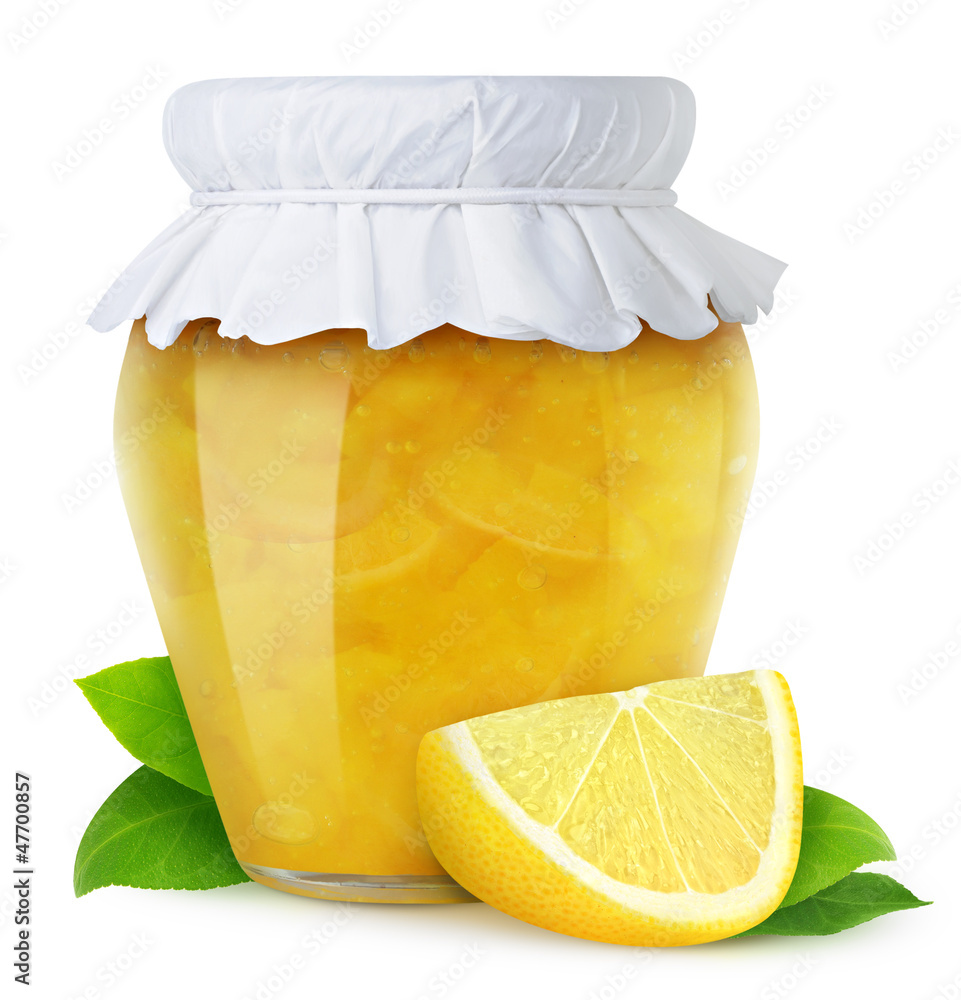 Isolated fruit jam. Closed glass jar of lemon marmalade and a piece of fresh fruit isolated on white