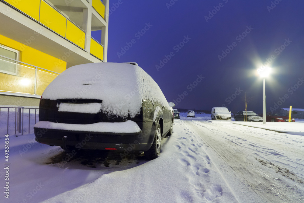 Snowy street with cars at winter in Poland