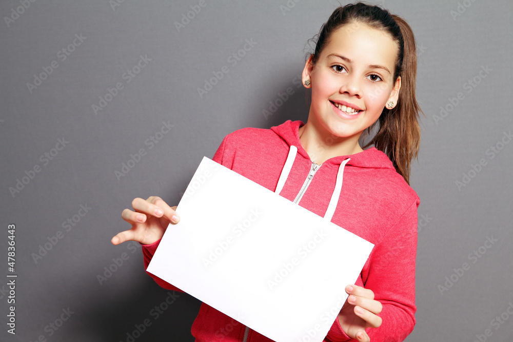 Beautiful little girl with blank paper